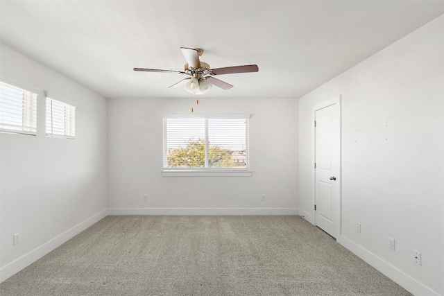 empty room featuring carpet flooring and ceiling fan