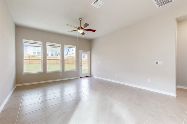 tiled spare room featuring ceiling fan