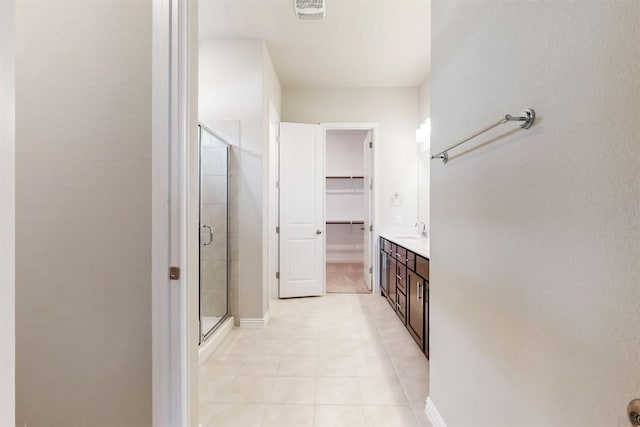 bathroom featuring tile patterned floors, vanity, and an enclosed shower