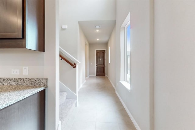 corridor featuring light tile patterned floors