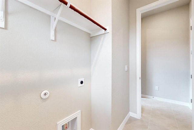 laundry room with hookup for an electric dryer and light tile patterned flooring