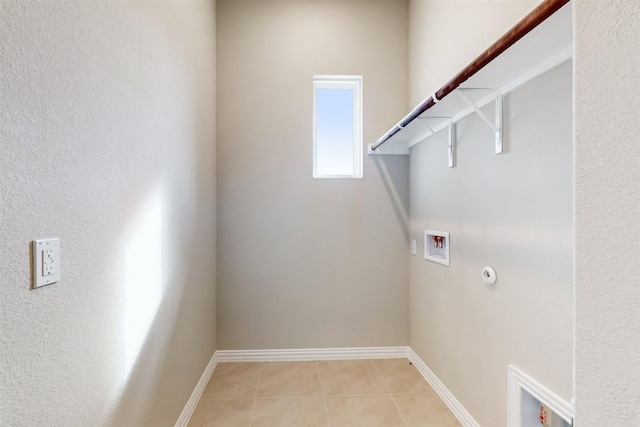 washroom with hookup for a gas dryer, light tile patterned flooring, and hookup for a washing machine