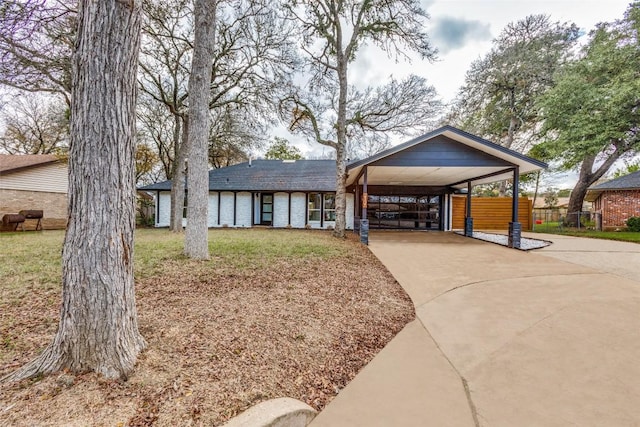 view of front facade featuring a carport and a front lawn