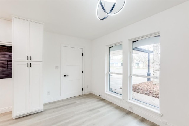 interior space with light wood-type flooring and a wealth of natural light