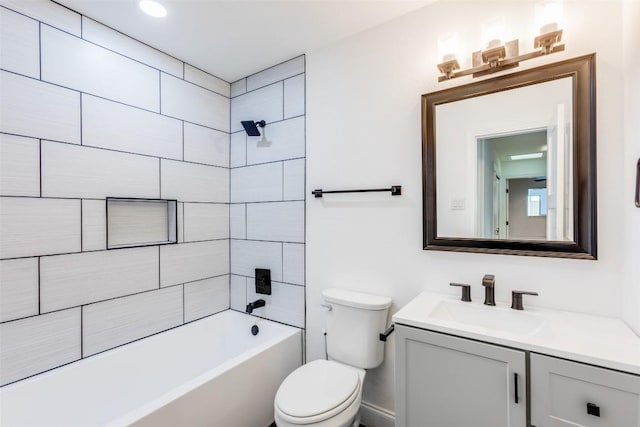 full bathroom featuring vanity, toilet, and tiled shower / bath