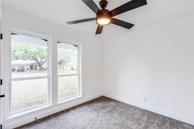 carpeted spare room with plenty of natural light and ceiling fan