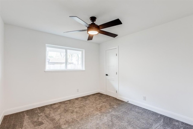 empty room with ceiling fan and carpet