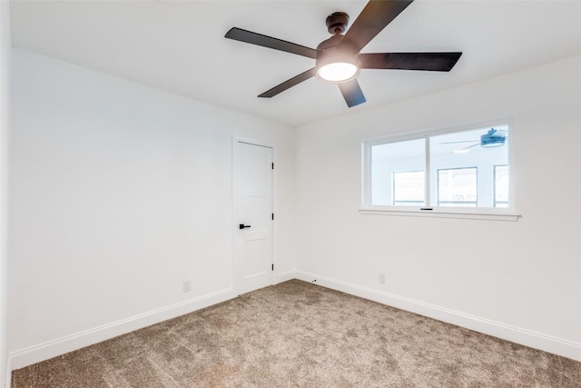 unfurnished room featuring light carpet and ceiling fan