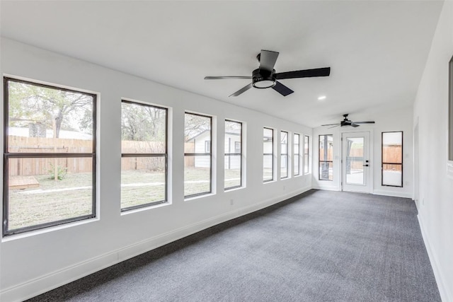 unfurnished sunroom with a wealth of natural light and ceiling fan