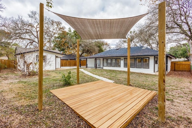 wooden deck with a lawn and an outdoor structure