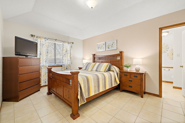 tiled bedroom featuring a raised ceiling