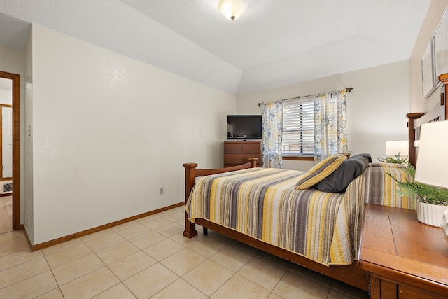 bedroom featuring lofted ceiling and light tile patterned floors