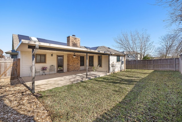 rear view of house with a yard and a patio