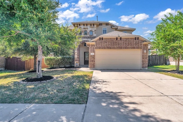 view of front of property featuring a garage and a front lawn