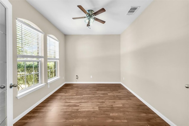 spare room featuring ceiling fan and dark wood-type flooring