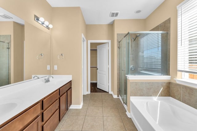 bathroom featuring tile patterned flooring, vanity, and separate shower and tub