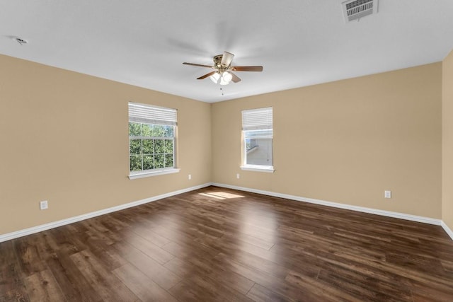 spare room with ceiling fan and dark wood-type flooring