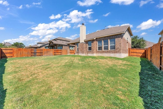 rear view of house featuring a yard