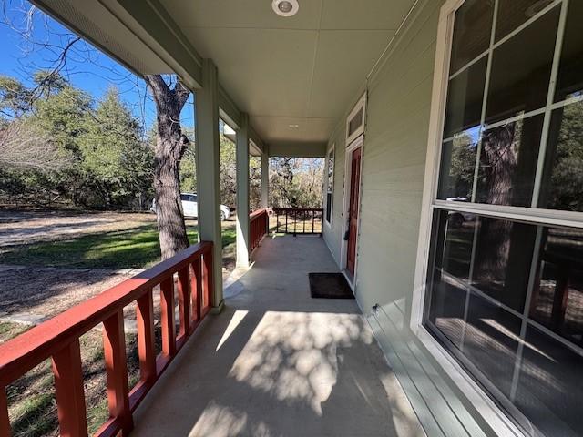 wooden terrace featuring covered porch