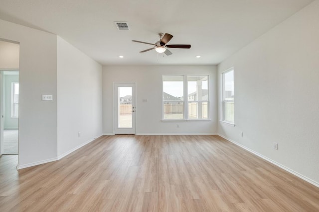 empty room featuring baseboards, visible vents, a ceiling fan, light wood-type flooring, and recessed lighting