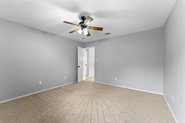 spare room with carpet floors and ceiling fan