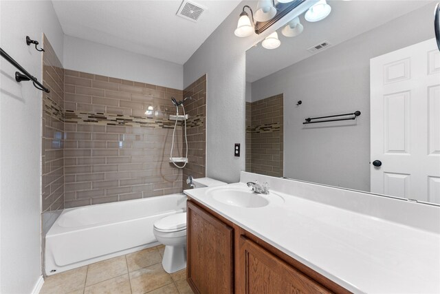 full bathroom featuring tile patterned floors, vanity, tiled shower / bath combo, and toilet