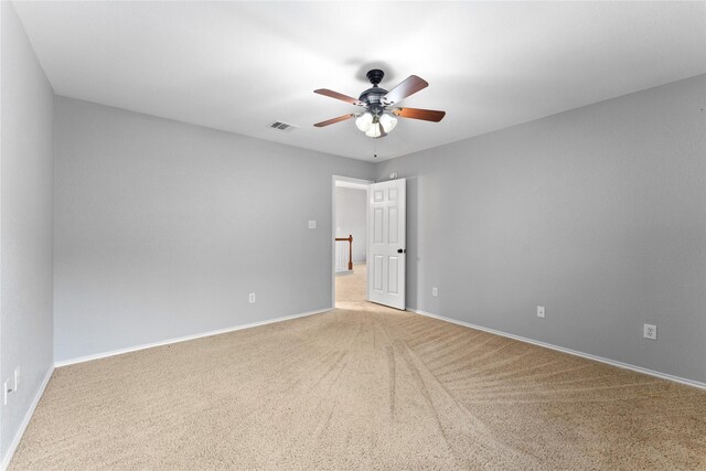 empty room with ceiling fan and carpet floors