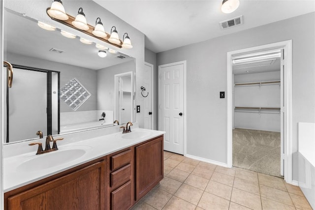 bathroom featuring a tub, tile patterned flooring, and vanity