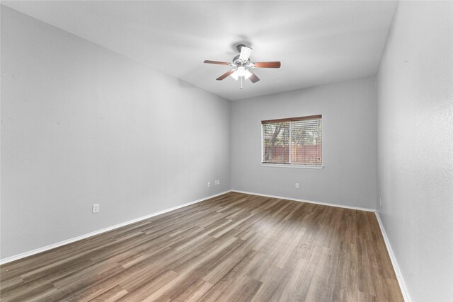 empty room featuring hardwood / wood-style flooring and ceiling fan