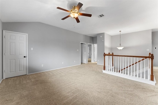 carpeted empty room with ceiling fan and vaulted ceiling