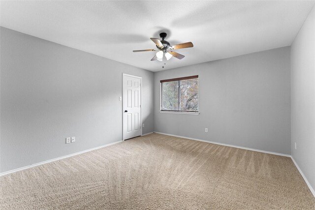 spare room featuring carpet flooring and ceiling fan