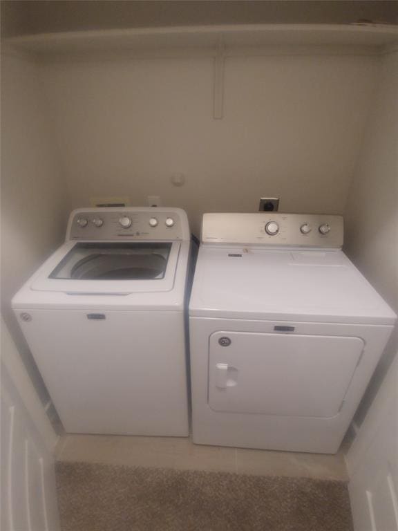 washroom featuring light tile patterned floors and separate washer and dryer