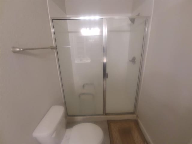 bathroom with toilet and walk in shower