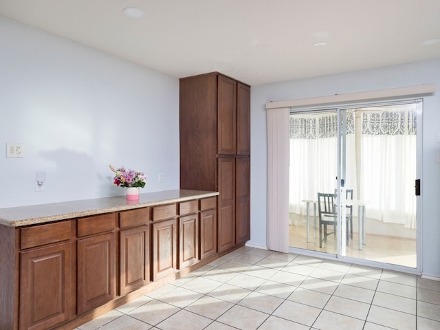 12400 Tay Ter, Austin, TX 78754 - kitchen with brown cabinets, light countertops, and light tile patterned floors