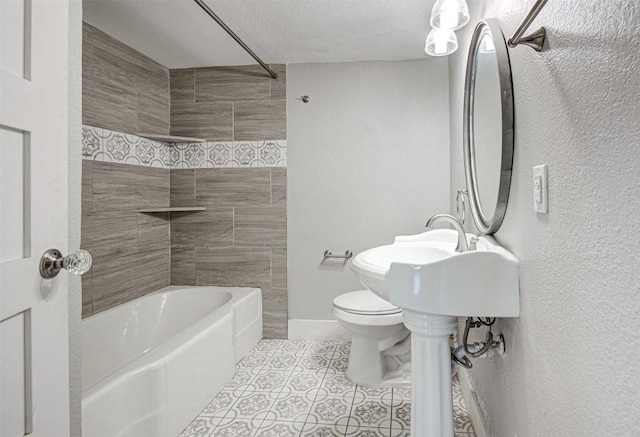 bathroom featuring tile patterned floors, tiled shower / bath combo, a textured ceiling, and toilet