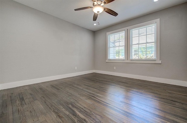 empty room featuring ceiling fan and dark wood-type flooring