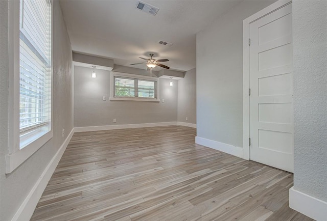 empty room featuring ceiling fan and light wood-type flooring