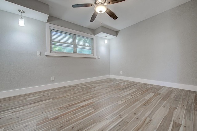 unfurnished room with light wood-type flooring and ceiling fan