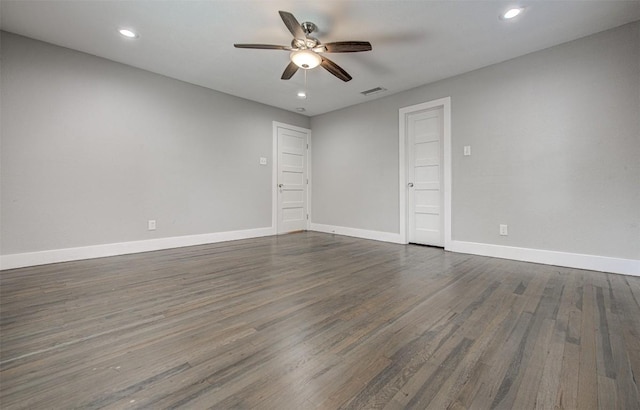 spare room with ceiling fan and dark wood-type flooring