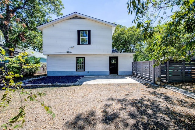 back of property with a patio