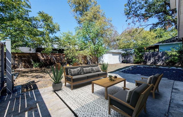 view of patio with outdoor lounge area and a shed