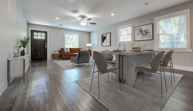 dining room with plenty of natural light, dark wood-type flooring, and ceiling fan