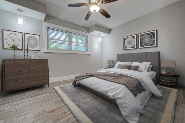 bedroom with light hardwood / wood-style flooring and ceiling fan