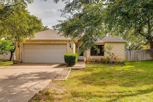 view of front of property with a garage and a front lawn