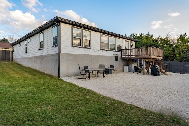 back of house with a yard and a deck