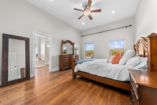 bedroom featuring ensuite bathroom, ceiling fan, and dark wood-type flooring