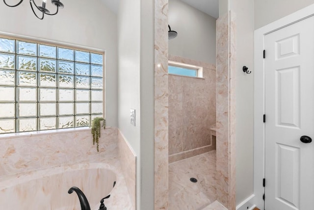 bathroom with a wealth of natural light and independent shower and bath