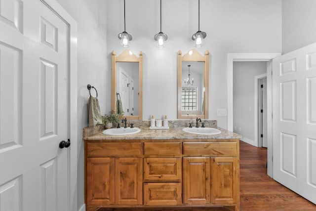 bathroom with a chandelier, vanity, and hardwood / wood-style flooring