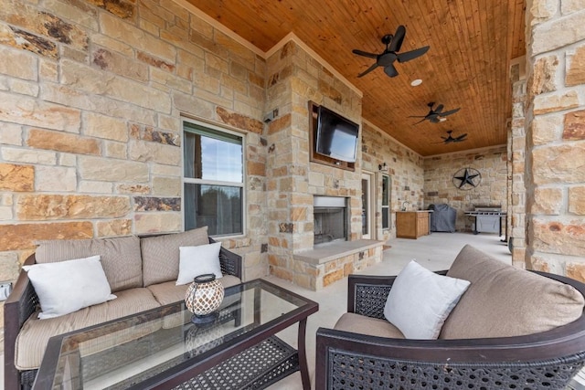 view of patio featuring an outdoor stone fireplace