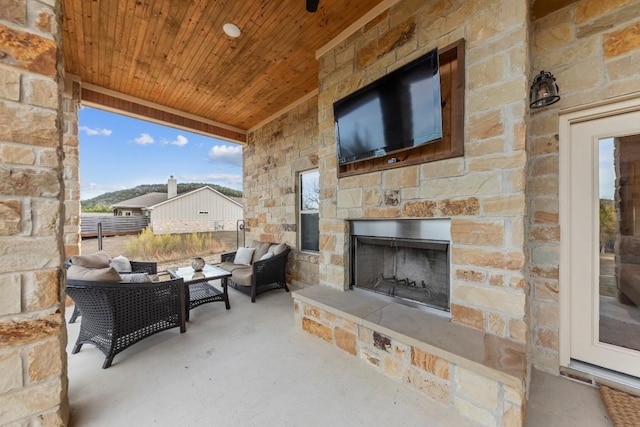 view of patio featuring an outdoor stone fireplace